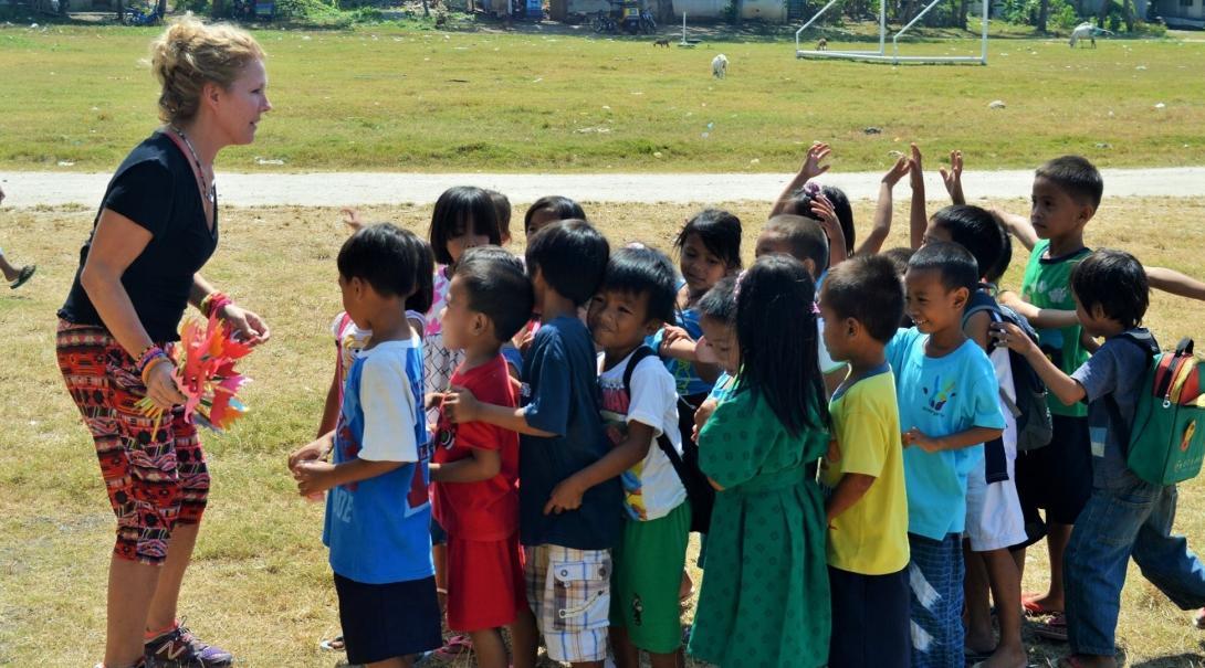 A Projects Abroad volunteer runs activities with children while getting sports coaching work experience in the Philippines A volunteer coaching sports in the Philippines prepares for a fun activity with children